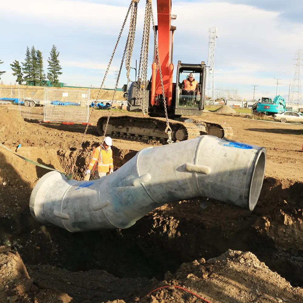 Humes Spun concrete pipe syphon being craned into place